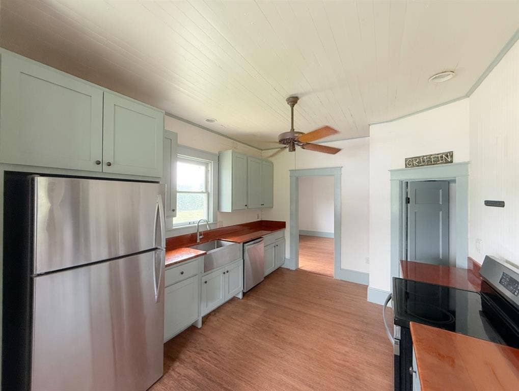 2749 Mcgregor South Loop, McGregor, TX 76657 Kitchen featuring light-toned cabinetry, wood-finish countertops, and wood-finish flooring