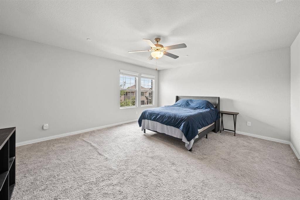 4129 Bullwhip Creek Lane, Sachse, TX 75048 Carpeted bedroom featuring neutral walls and a ceiling fan with integrated lighting