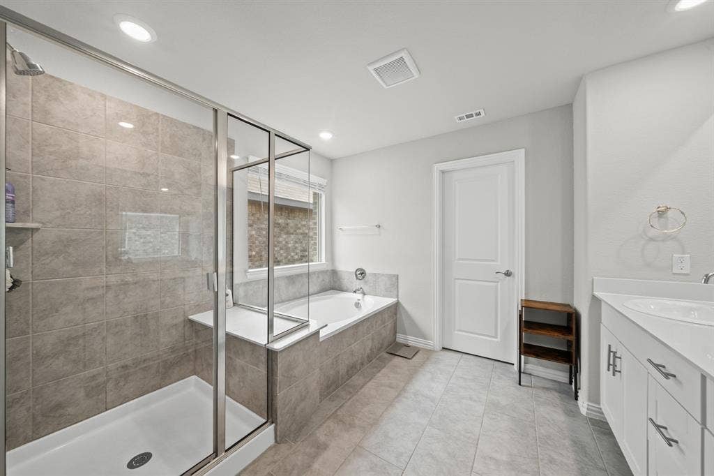4129 Bullwhip Creek Lane, Sachse, TX 75048 Tiled shower with glass enclosure and built-in bench
