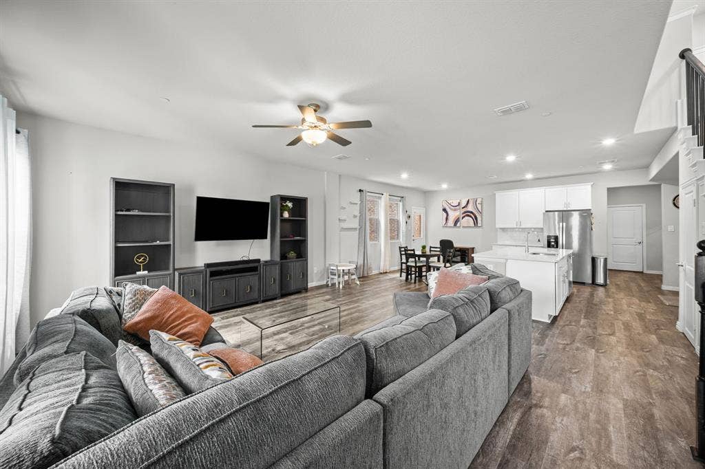 4129 Bullwhip Creek Lane, Sachse, TX 75048 Open-concept living space featuring wood-finish flooring, recessed lighting, and a ceiling fan