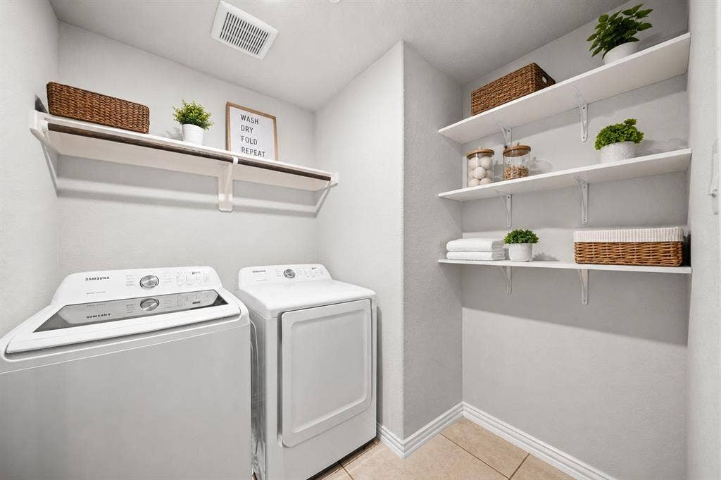 4129 Bullwhip Creek Lane, Sachse, TX 75048 Dedicated laundry area featuring a built-in folding shelf, overhead hanging rod, and multiple wall-mounted storage shelves