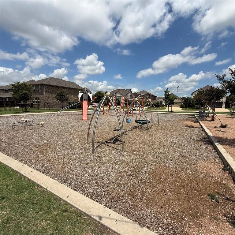 4129 Bullwhip Creek Lane, Sachse, TX 75048 Community playground featuring multiple swings, a slide structure, and a circular spinner