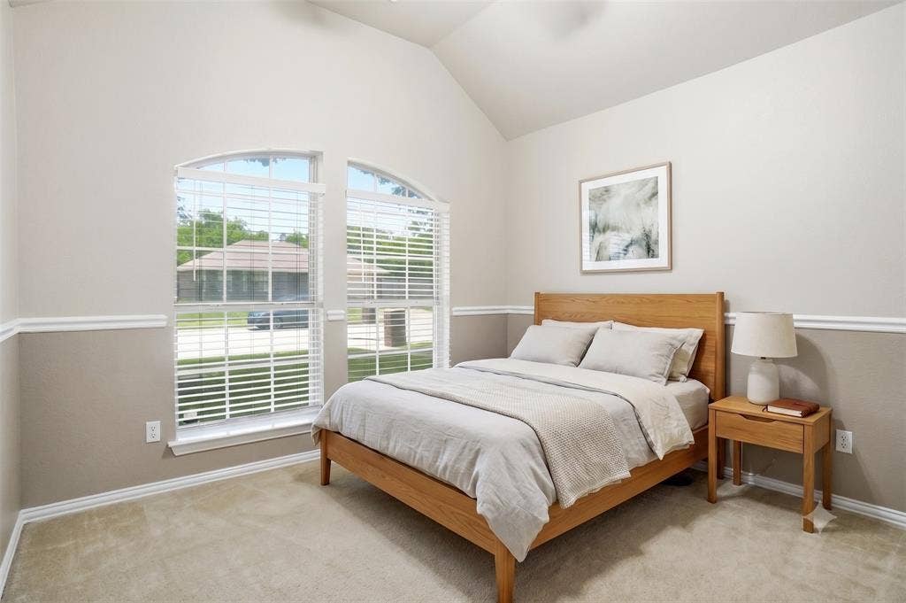 Bedroom 2 with vaulted 12 ft ceiling,  fan, chair rail accent and full wall closet