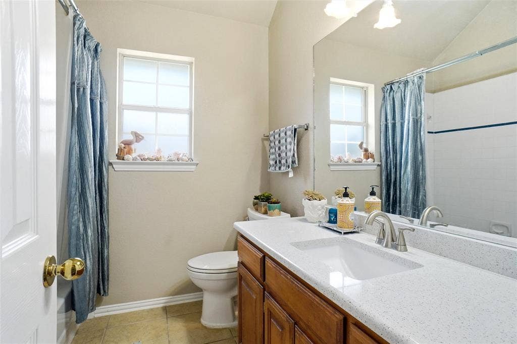 7x7 spacious hall bath with dual quartz vanities, linen closet, new faucets and vanity light