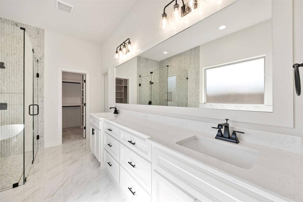902 Boston Lane, River Oaks, TX 76114 Dual vanity with white cabinetry, integrated sinks, and matte black fixtures