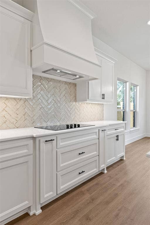 902 Boston Lane, River Oaks, TX 76114 Contemporary kitchen showcasing white cabinetry, a built-in cooktop, white countertops, and a herringbone-patterned tile backsplash