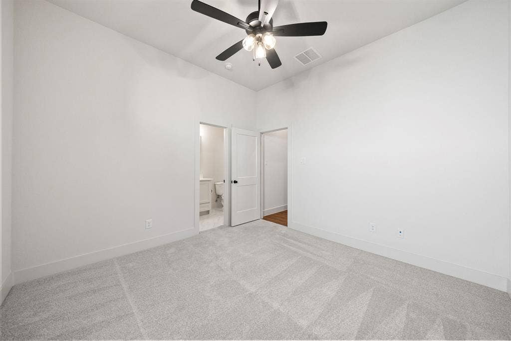 902 Boston Lane, River Oaks, TX 76114 Carpeted interior space with a ceiling fan light fixture, flat white walls, and white trim
