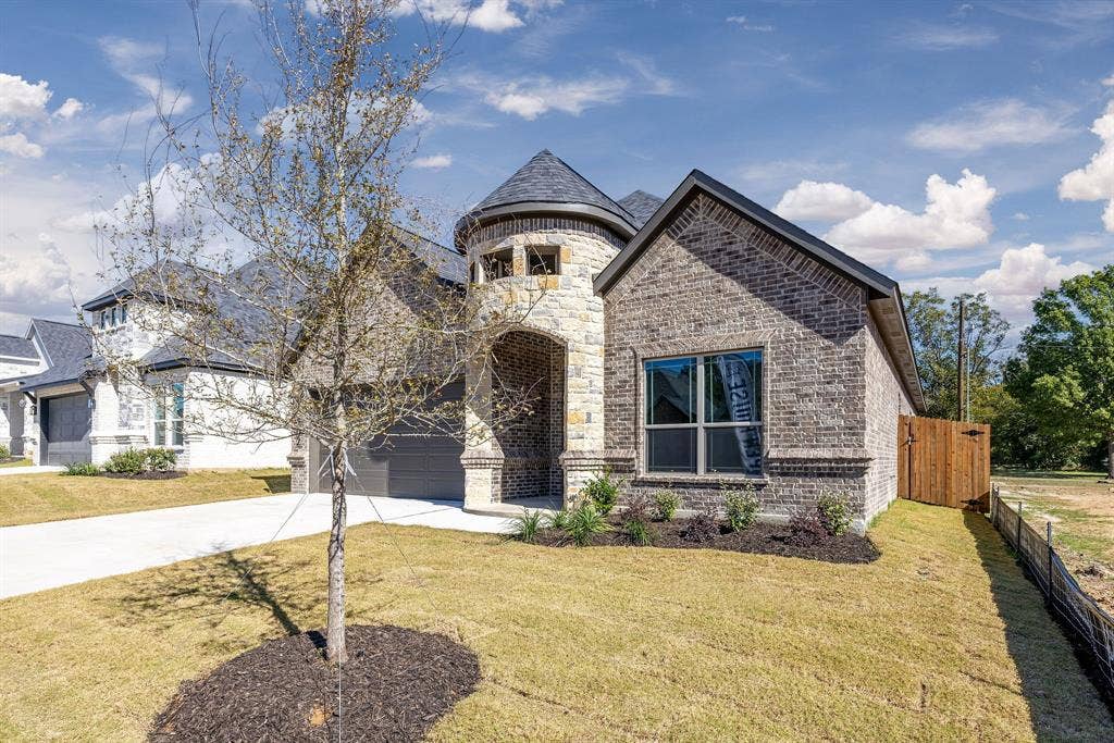 902 Boston Lane, River Oaks, TX 76114 Distinguished exterior featuring a natural stone turret and a brick facade