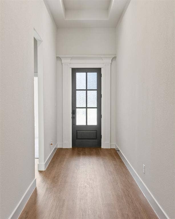 902 Boston Lane, River Oaks, TX 76114 Entryway featuring a dark paneled door with glass inserts, detailed white trim, and wood-finish flooring