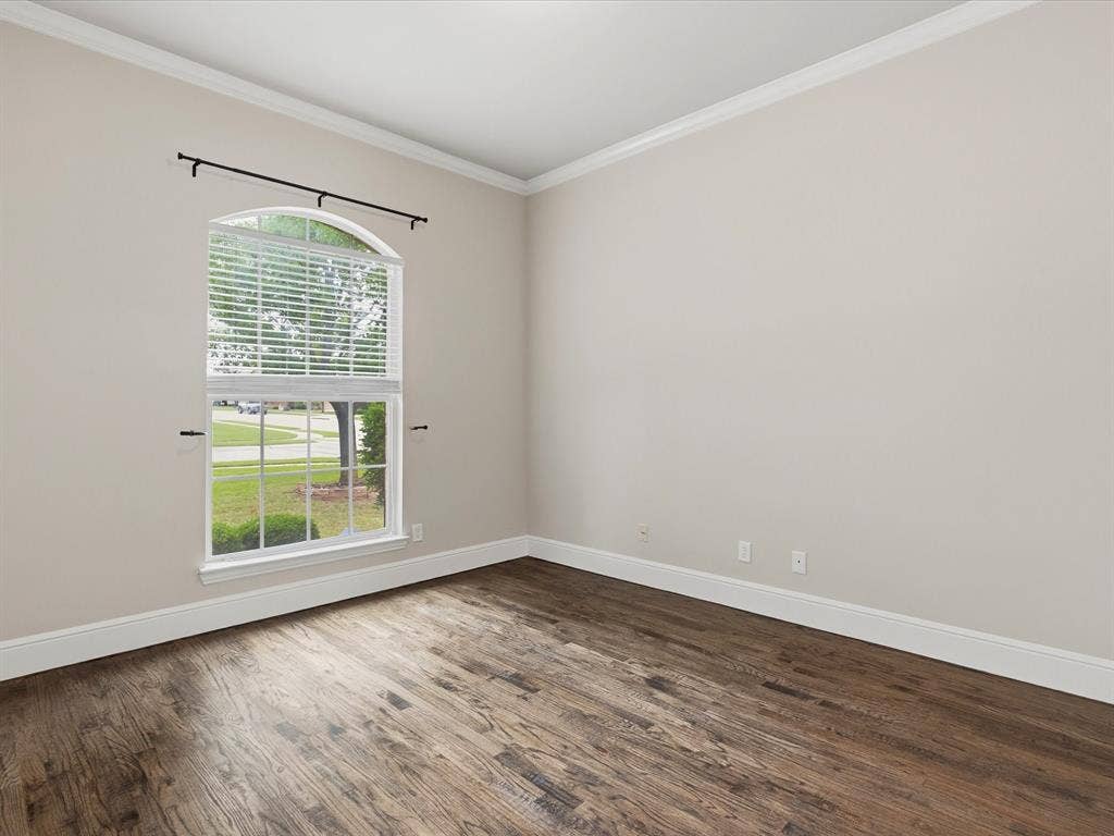 1621 Lakemere Drive, Prosper, TX 75078 Spacious room featuring wood-finish flooring, light neutral wall tones, and white crown molding