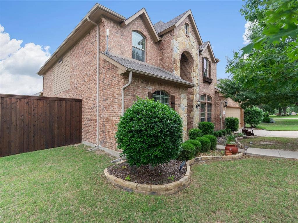 1621 Lakemere Drive, Prosper, TX 75078 Brick and stone facade featuring arched windows and decorative shutters