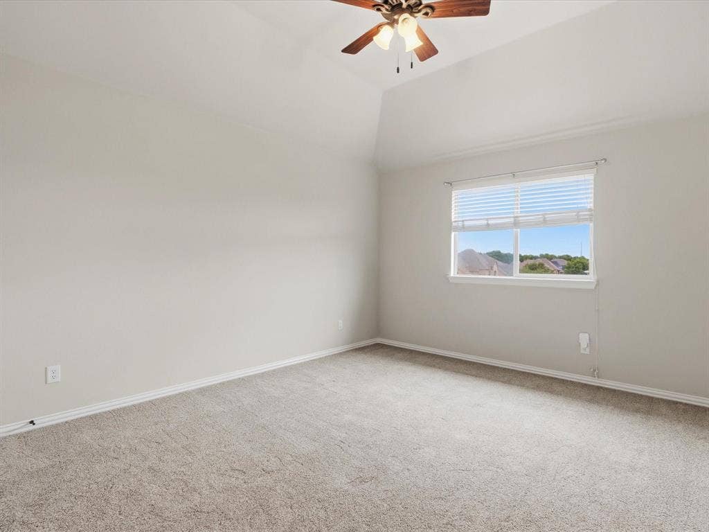 1621 Lakemere Drive, Prosper, TX 75078 Carpeted room featuring a single window with blinds, a vaulted ceiling, and a ceiling fan with integrated lighting