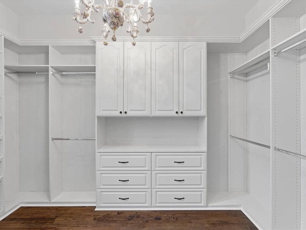 1621 Lakemere Drive, Prosper, TX 75078 Custom closet system with built-in cabinetry and drawers, wood-finish flooring, and decorative overhead lighting