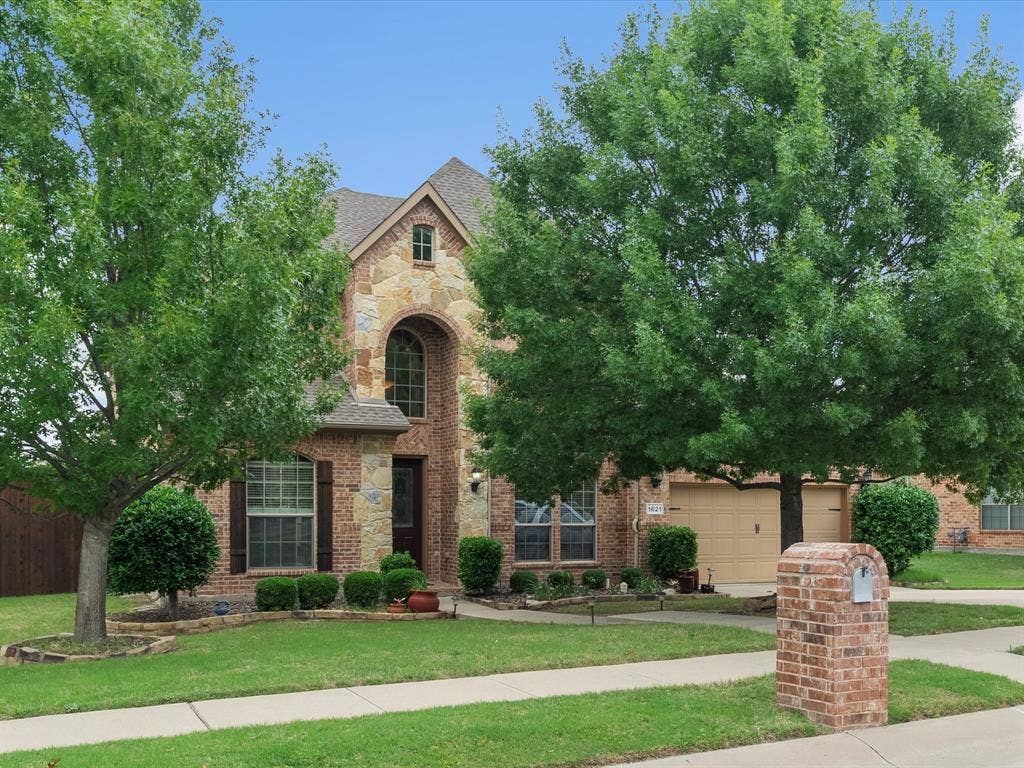 1621 Lakemere Drive, Prosper, TX 75078 Stone and brick facade residence featuring an arched entryway