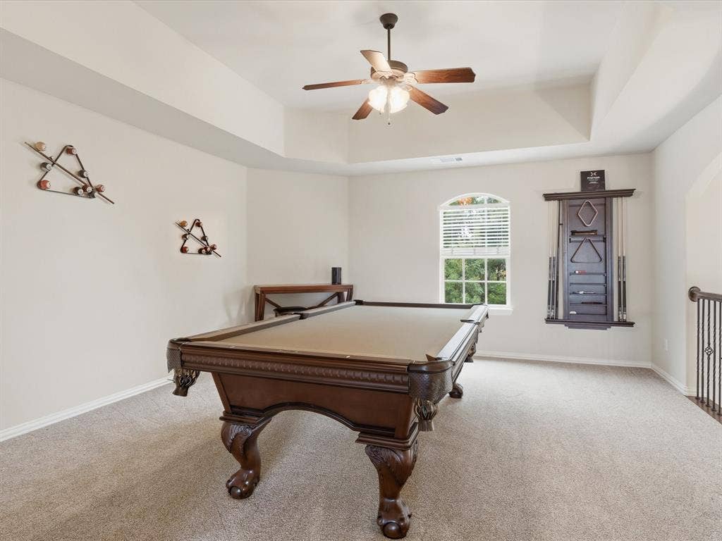 1621 Lakemere Drive, Prosper, TX 75078 Spacious bonus room featuring a tray ceiling with a ceiling fan, arched window, and plush carpet flooring