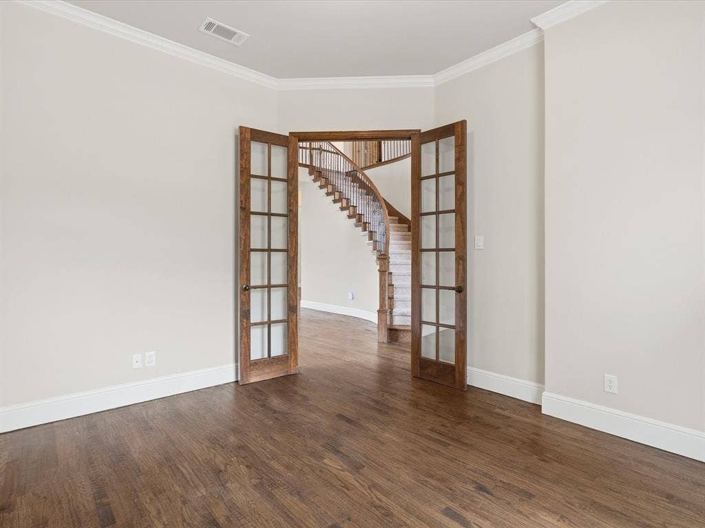 1621 Lakemere Drive, Prosper, TX 75078 French doors with multiple lites open to a curved staircase with wood treads and white risers