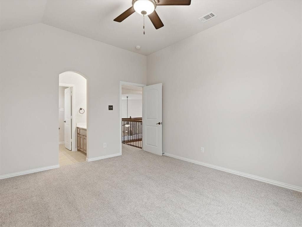 1621 Lakemere Drive, Prosper, TX 75078 Spacious carpeted room featuring a vaulted ceiling and a ceiling fan with integrated lighting