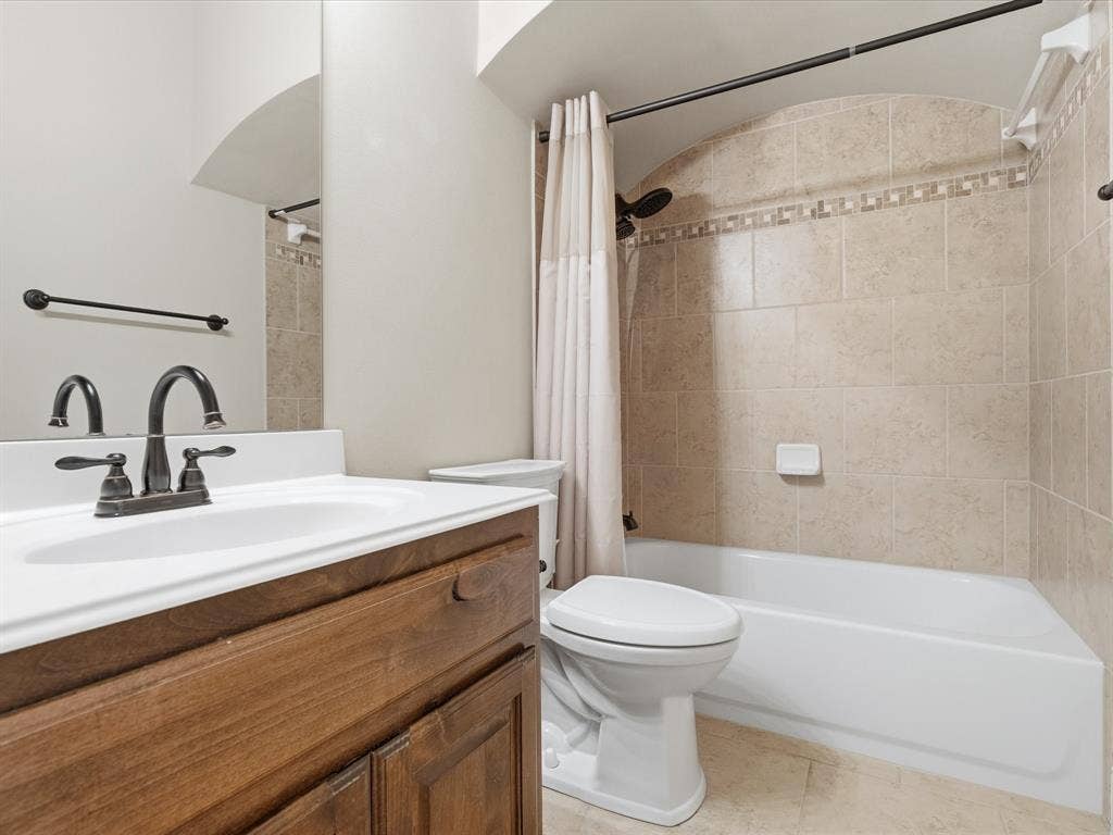1621 Lakemere Drive, Prosper, TX 75078 Bathroom featuring a white vanity with integrated sink, dark bronze-finish faucet, and coordinating towel bar