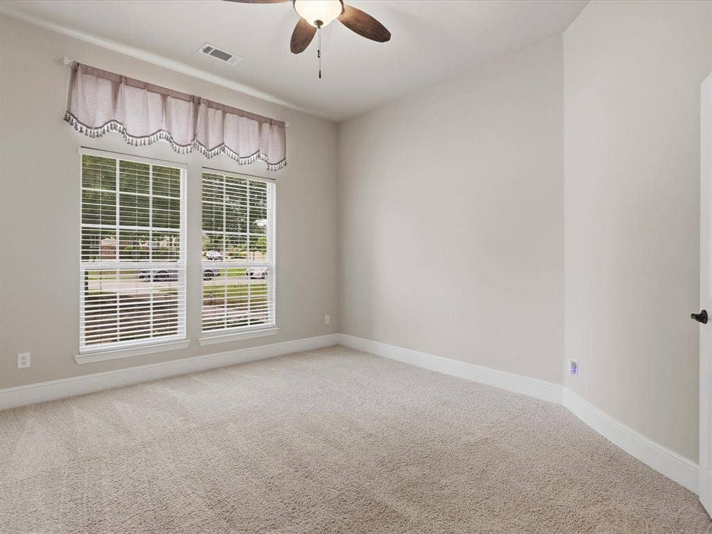 1621 Lakemere Drive, Prosper, TX 75078 Carpeted room featuring two large windows with horizontal blinds, a ceiling fan with integrated lighting, and neutral wall tones
