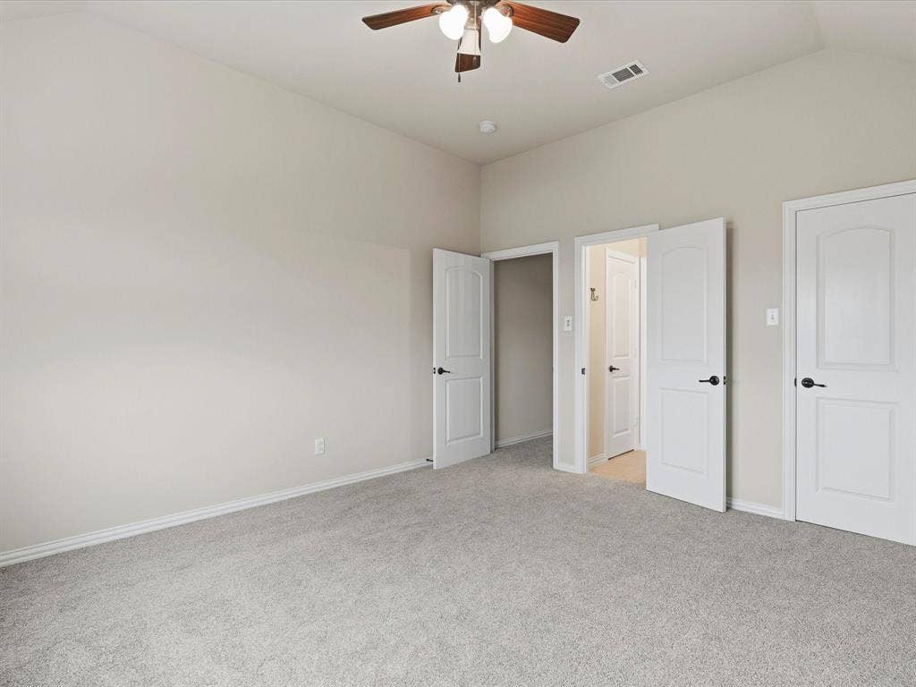 1621 Lakemere Drive, Prosper, TX 75078 Spacious room featuring vaulted ceilings, soft gray carpeting, and light neutral wall paint