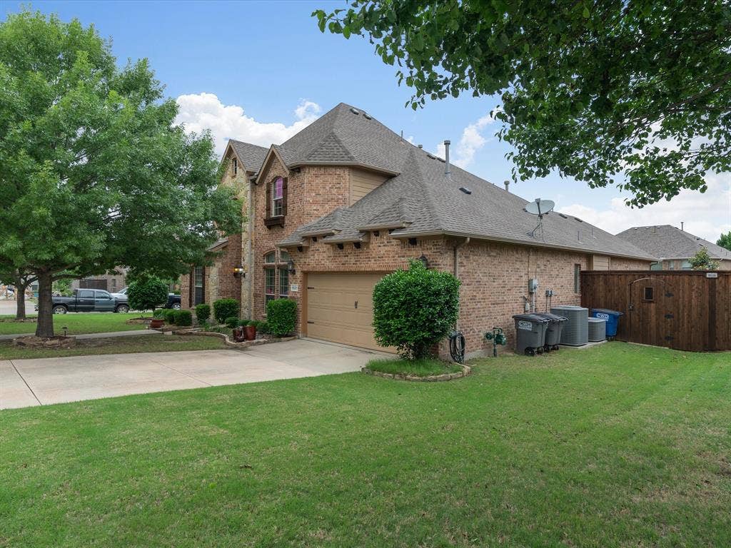 1621 Lakemere Drive, Prosper, TX 75078 Brick exterior featuring multiple gables and an attached two-car garage