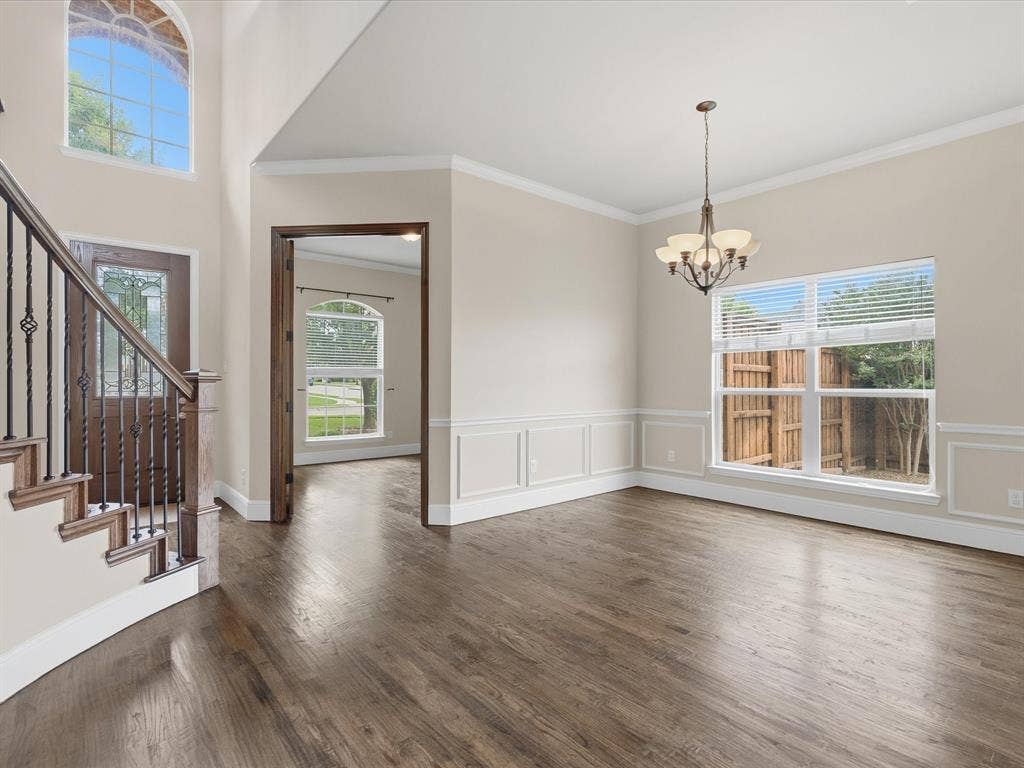 1621 Lakemere Drive, Prosper, TX 75078 Expansive room with wood-finish flooring, wainscoting, and crown molding