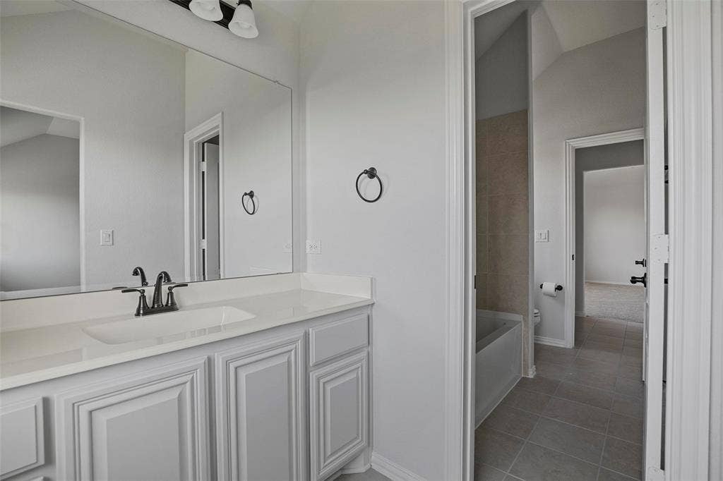 508 Bush Avenue, Waxahachie, TX 75165 Vanity with undermount sink, dark bronze faucet, and light countertop