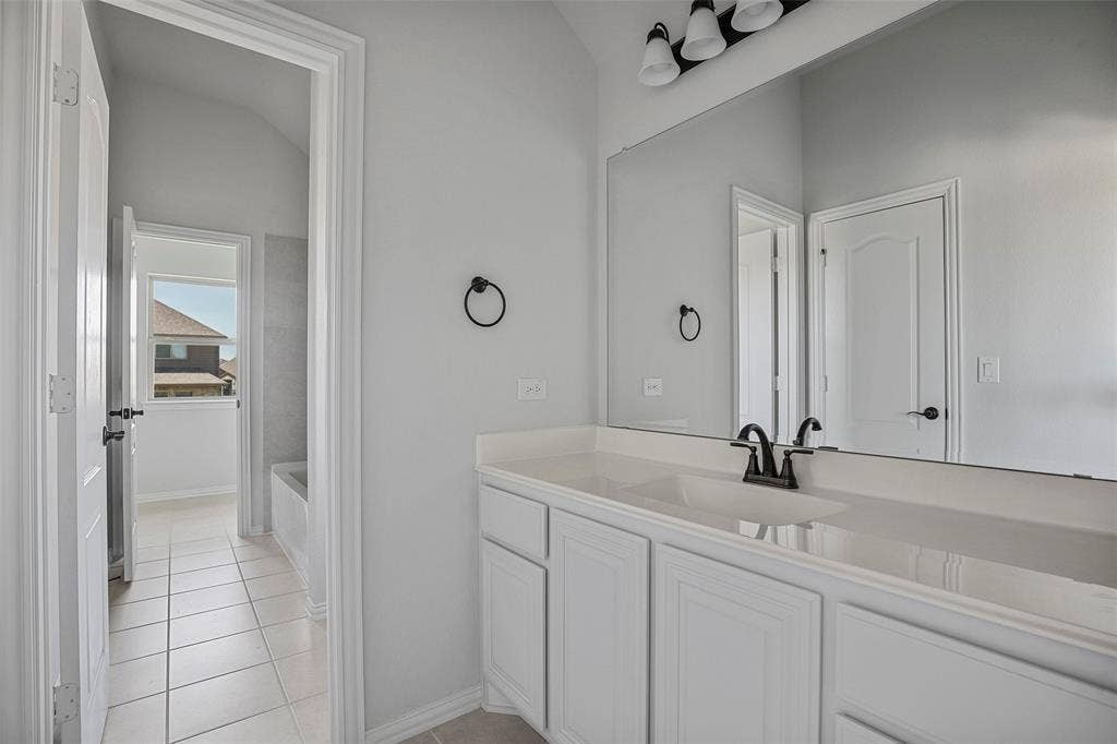 508 Bush Avenue, Waxahachie, TX 75165 Vanity with white cabinetry, a single basin, and a dark-finish faucet