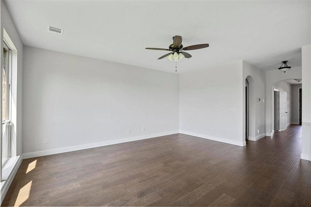 508 Bush Avenue, Waxahachie, TX 75165 Spacious room with wood-finish flooring, light gray wall paint, and white baseboards