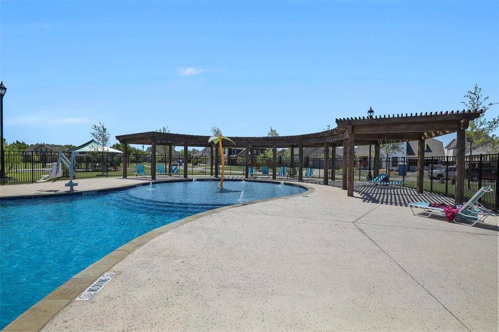 508 Bush Avenue, Waxahachie, TX 75165 Community swimming pool featuring a shallow entry, water features, and a surrounding concrete deck