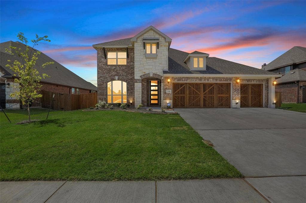 508 Bush Avenue, Waxahachie, TX 75165 Brick and stone facade featuring a prominent arched window and a contemporary entryway