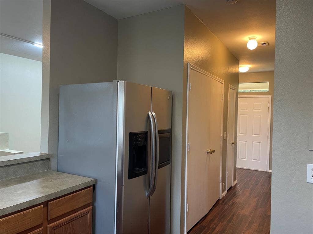 817 Greene Way, Wylie, TX 75098 Hallway with wood-finish flooring, flush mount lighting, and multiple panel doors