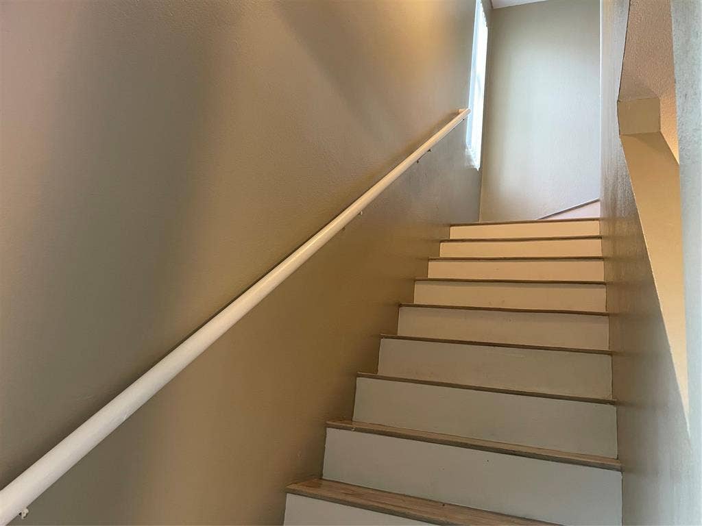 817 Greene Way, Wylie, TX 75098 Staircase featuring wood-finish treads and risers, a white handrail, and light tan wall paint