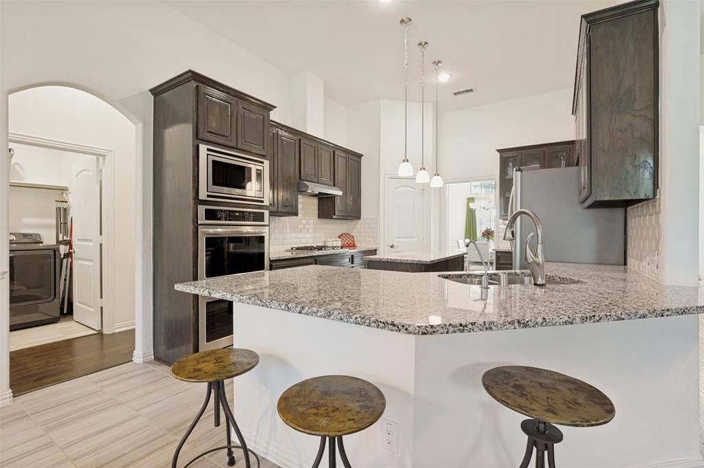 824 State Street, DeSoto, TX 75115 The kitchen has an island and breakfast bar.