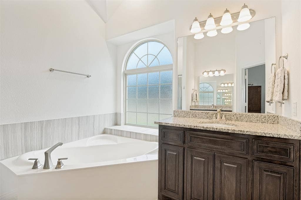 824 State Street, DeSoto, TX 75115 Primary bath feels like a private spa with garden tub and separate shower.