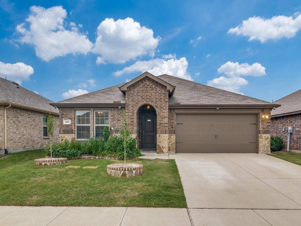 709 Darlington Oak Avenue, Royse City, TX 75189 Brick exterior with stone accents and an arched entry