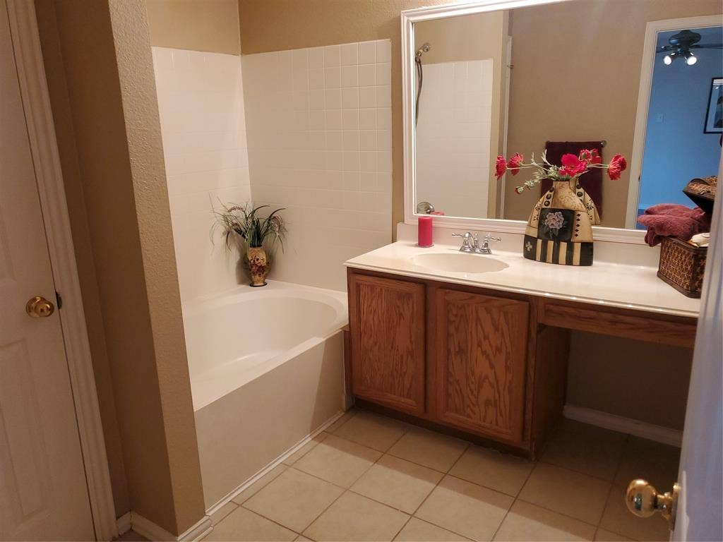 5005 Boxwood Lane, McKinney, TX 75070 Primary bath has tiled floor, garden tub and linen closet.