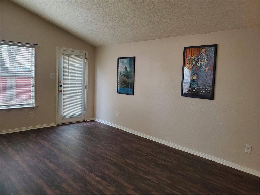 5005 Boxwood Lane, McKinney, TX 75070 View of family room with vaulted ceiling and walls of windows.