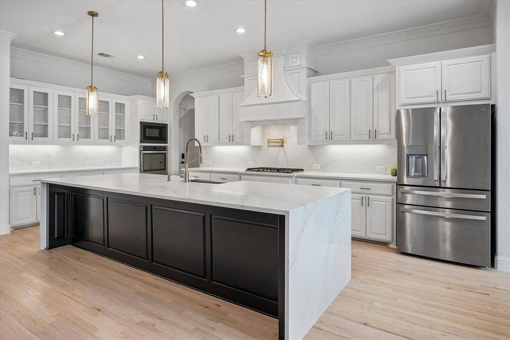 1620 Cattle Drive, Prosper, TX 75078 Beautiful Pendant Lights above Island, Pot Filler at cooktop and glass doors in some cabinets
