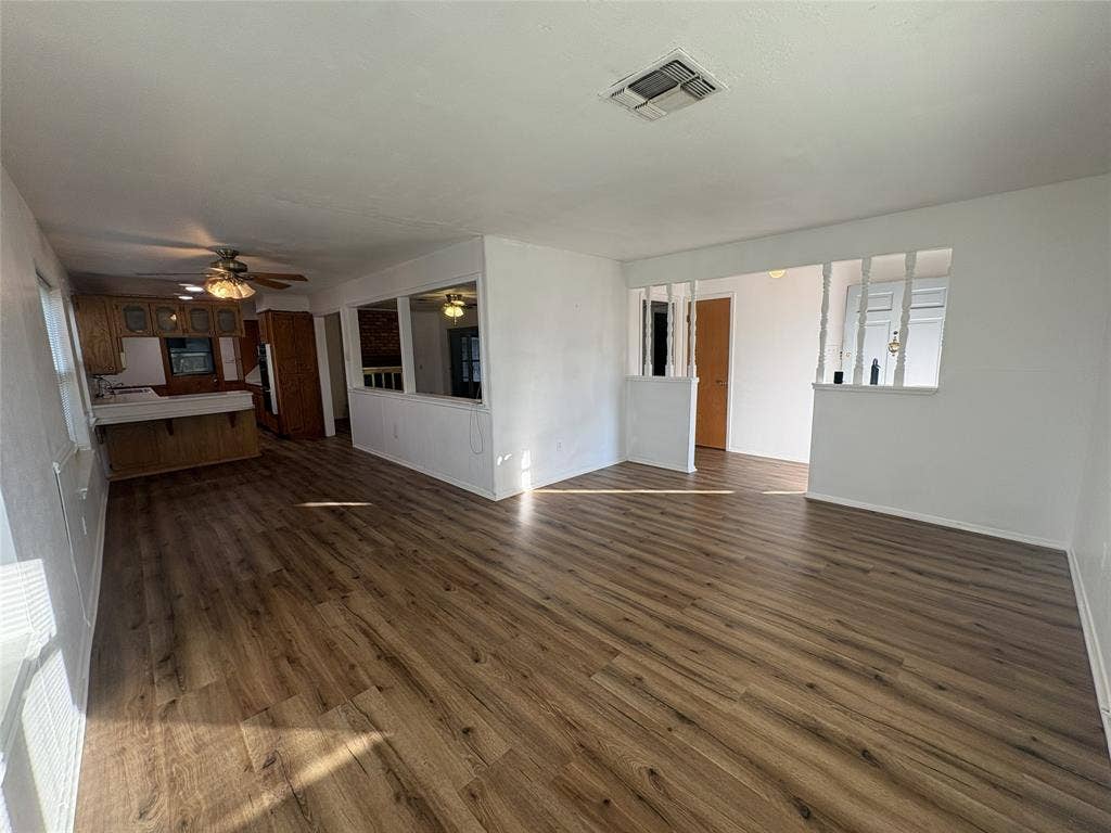 6100 Landmark Drive, Waco, TX 76710 Expansive room featuring wood-finish flooring, white walls, and a recessed ceiling vent