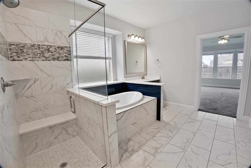 620 Shadow Trail, Frisco, TX 75033 Contemporary bathroom featuring a walk-in shower with a glass enclosure, a built-in bench, and a mosaic tile accent band