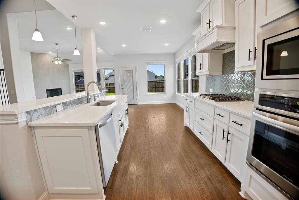 620 Shadow Trail, Frisco, TX 75033 Modern kitchen featuring white cabinetry, light-toned countertops, and stainless steel appliances