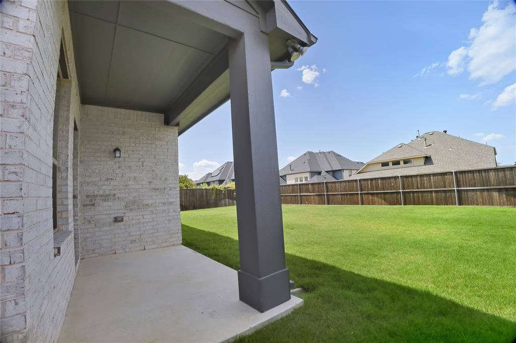 620 Shadow Trail, Frisco, TX 75033 Covered patio with a concrete slab, white brick exterior, and a dark-finished support column