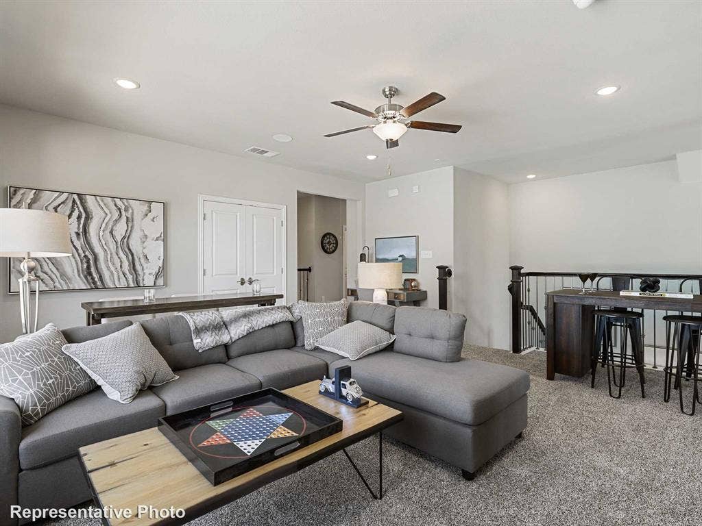 1317 Staffords Point Lane, Anna, TX 75409 Spacious living area featuring light gray walls and plush gray carpeting