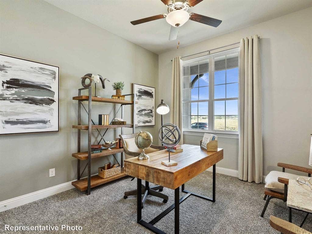 1317 Staffords Point Lane, Anna, TX 75409 Spacious room featuring a large window with window treatments, a ceiling fan with light fixture, light gray wall paint, white baseboards, and carpet flooring