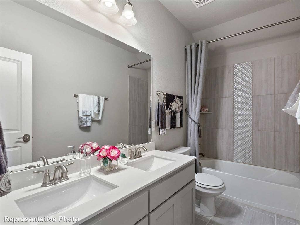 1317 Staffords Point Lane, Anna, TX 75409 Bathroom featuring a dual vanity with undermount sinks, a white countertop, and brushed nickel fixtures
