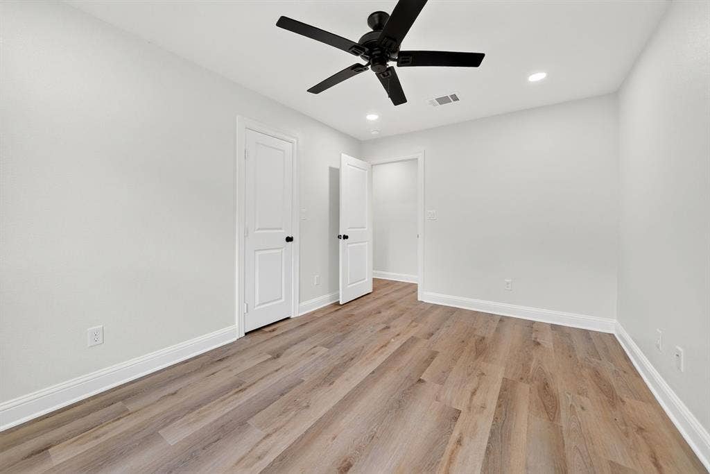 608 Bunny Rabbit Road, Athens, TX 75751 Spacious room featuring wood-finish flooring, white baseboards, and bright white walls