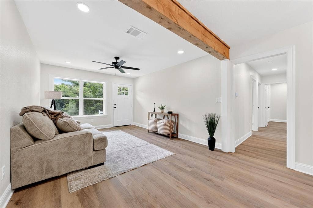 608 Bunny Rabbit Road, Athens, TX 75751 Open living area featuring wood-finish flooring, a prominent wooden beam accent, recessed lighting, and a contemporary ceiling fan