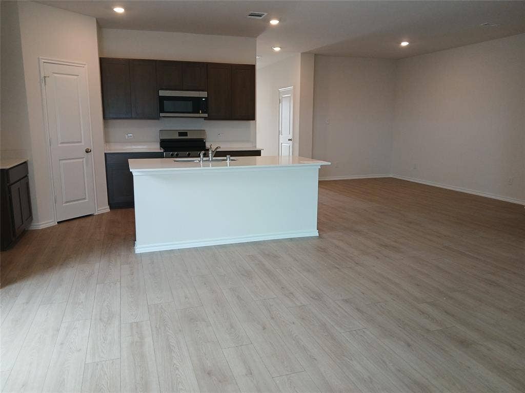 312 Whispering Pine Drive, Royse City, TX 75189 Open-concept living space featuring wood-finish flooring throughout