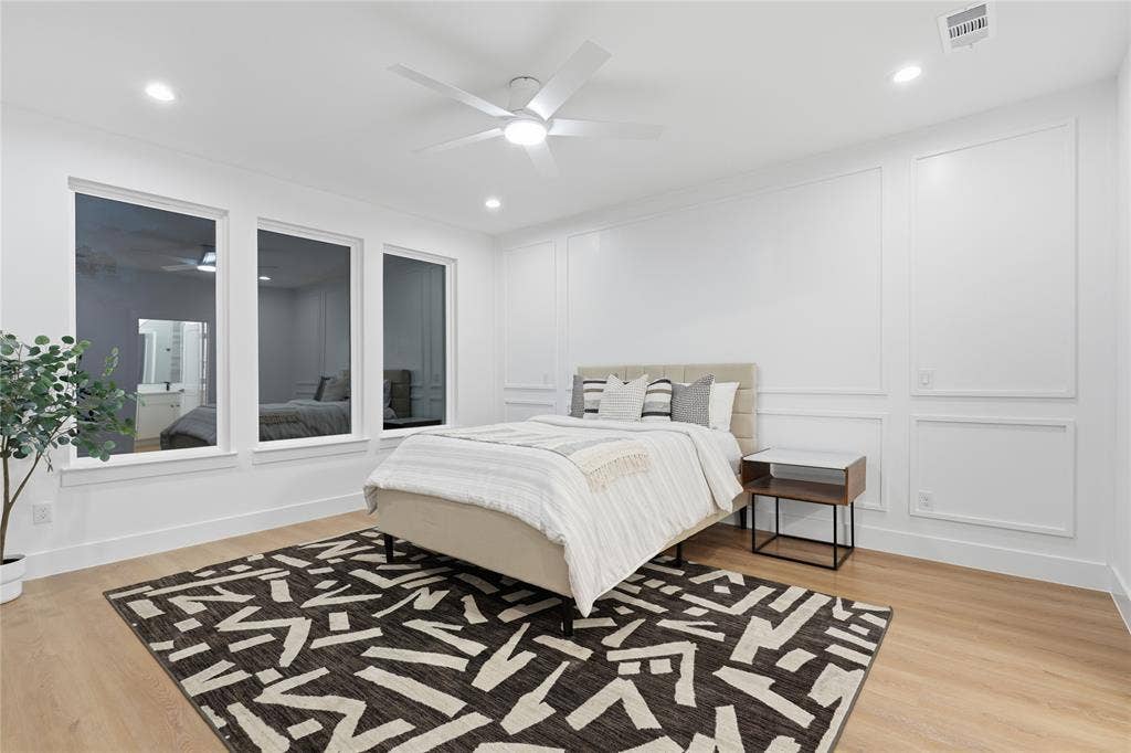 2212 Marburg Street, Dallas, TX 75215 Spacious room featuring three large windows, wood-finish flooring, and recessed lighting